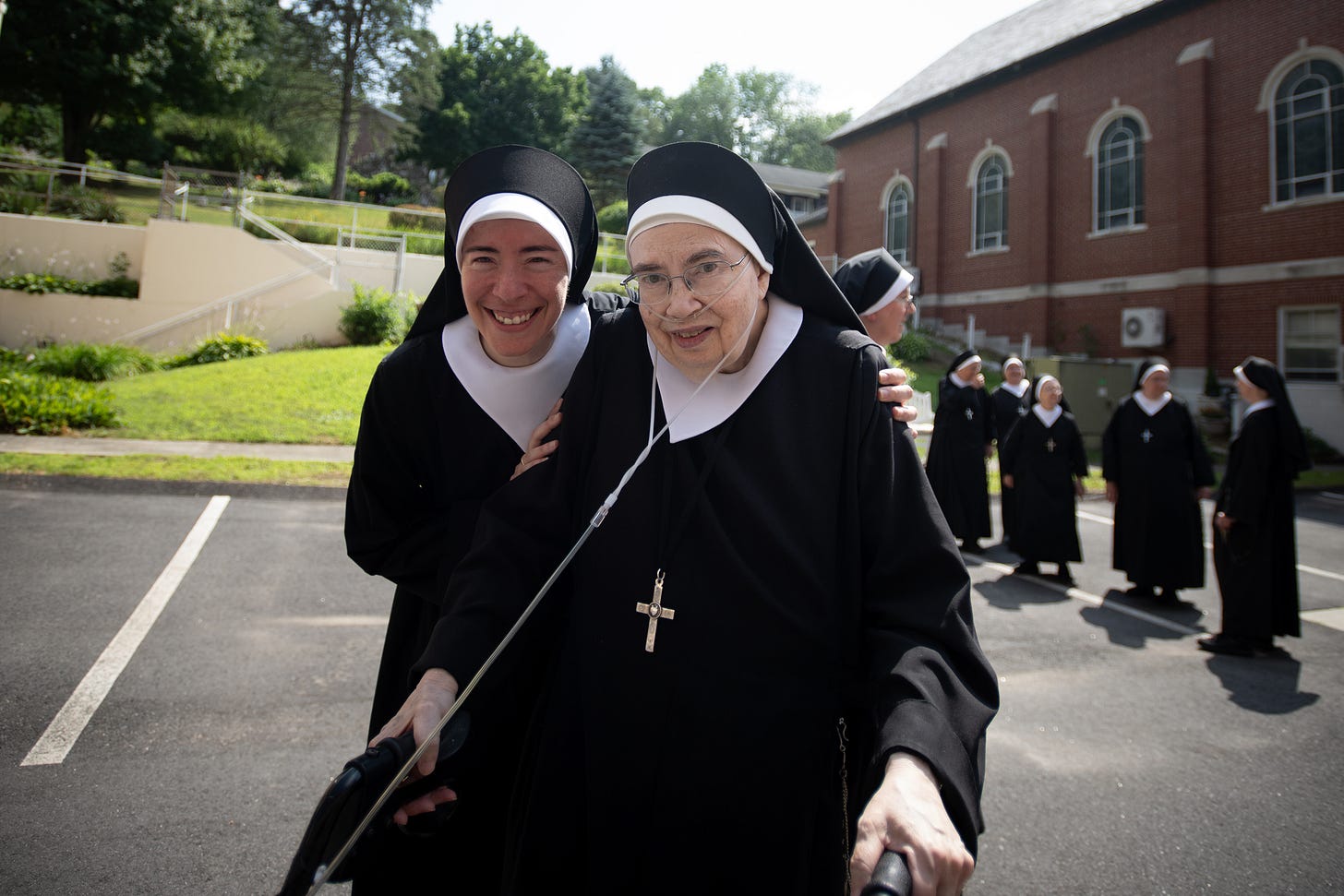 Two Sisters laugh together before the community portrait