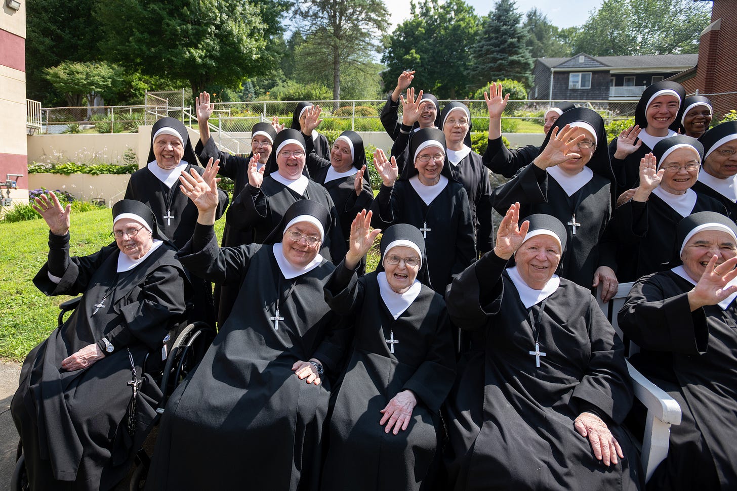 The Sisters gather closely for a joyful community photograph